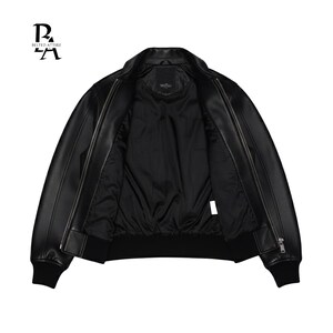 May include: Black leather bomber jacket with a zip closure, ribbed cuffs, and a ribbed hem. The jacket is open, revealing a black interior lining. The brand logo "BELTED ATTIRE" is visible in the upper left corner.