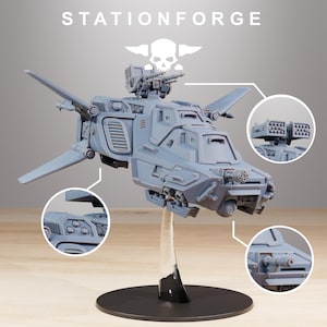 May include: A light grey model of a futuristic aircraft with wings, turrets, and missile launchers. The model is mounted on a clear stand with a black base. The text "STATIONFORGE" is at the top.