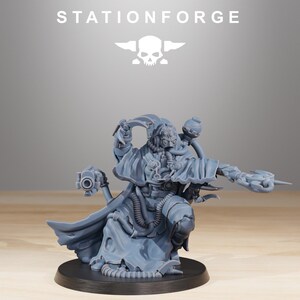 May include: A gray miniature figure of a futuristic warrior, posed in a dynamic stance. The figure is detailed with mechanical components, a flowing cloak, and a weapon. The text "STATIONFORGE" and a skull logo are at the top.