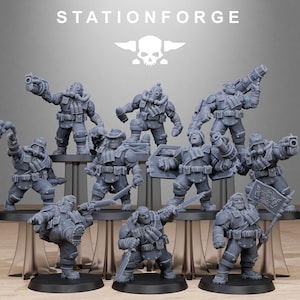 May include: A group of grey miniature soldier figurines in dynamic poses. The figurines are displayed on a black surface, with the text "STATIONFORGE" and a skull logo visible in the background.