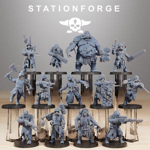 May include: A selection of grey miniature figurines, featuring soldiers and a large figure. The figurines are displayed on clear stands, with the text "STATIONFORGE" and a skull logo above. The figures are detailed with weapons and armour.