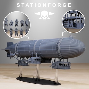 May include: A grey model airship with several gondolas suspended beneath. The model includes miniature figures and the text "STATIONFORGE" above a skull logo. The zeppelin is supported by clear stands on a black base.