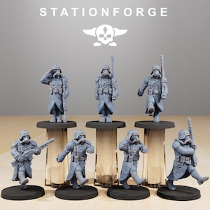 May include: A set of grey miniature soldier figurines in military uniforms, gas masks, and helmets. The figurines are mounted on black circular bases. The word "STATIONFORGE" is printed at the top of the image, along with a skull logo.