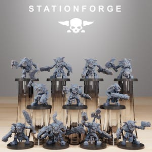 May include: A collection of gray miniature figurines of goblin-like creatures, each with unique weapons and poses. The figurines are displayed on black stands, with the "STATIONFORGE" logo and a skull graphic at the top.