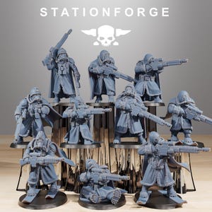 May include: A collection of gray miniature figurines of soldiers in winter coats, gas masks, and rifles. The figures are arranged on a tiered display. The text "STATIONFORGE" is at the top.