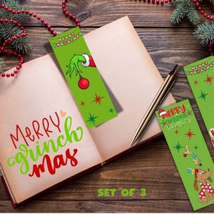 Set of 3 printable Grinch Christmas bookmarks displayed in an open book