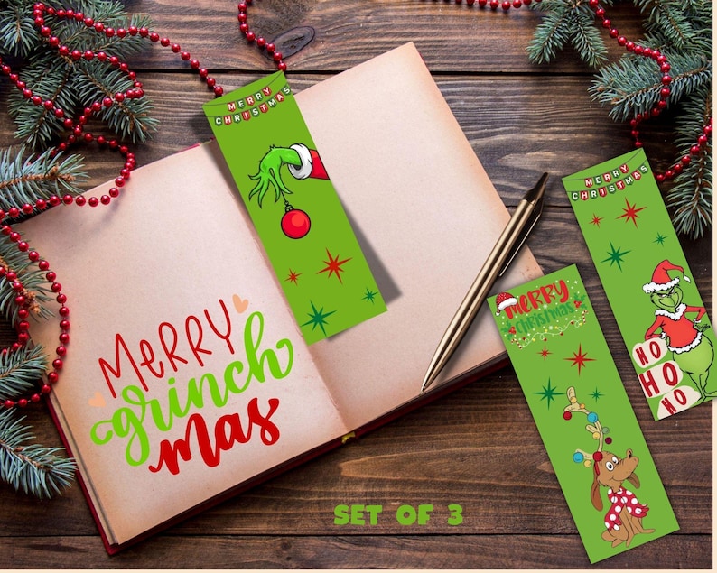 Set of 3 printable Grinch Christmas bookmarks displayed in an open book