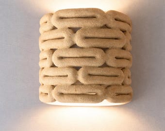 Handcrafted ceramic wall sconce in space age style, made of red stoneware