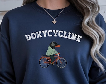 Doxycycline Sweatshirt, Dachshund On Bicycle , veterinary Pun shirt, pharmacist sweatshirt, Veterinary Pharmacists Technicians Sweatshirt