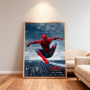 May include: A framed poster for the film Spider-Man, showing the superhero in a red and blue suit, leaping over a city. The poster has a wooden frame and includes the text "SPIDER-MAN BRAND NEW DAY" and "REALD 3D IMAX". The background is a cityscape.