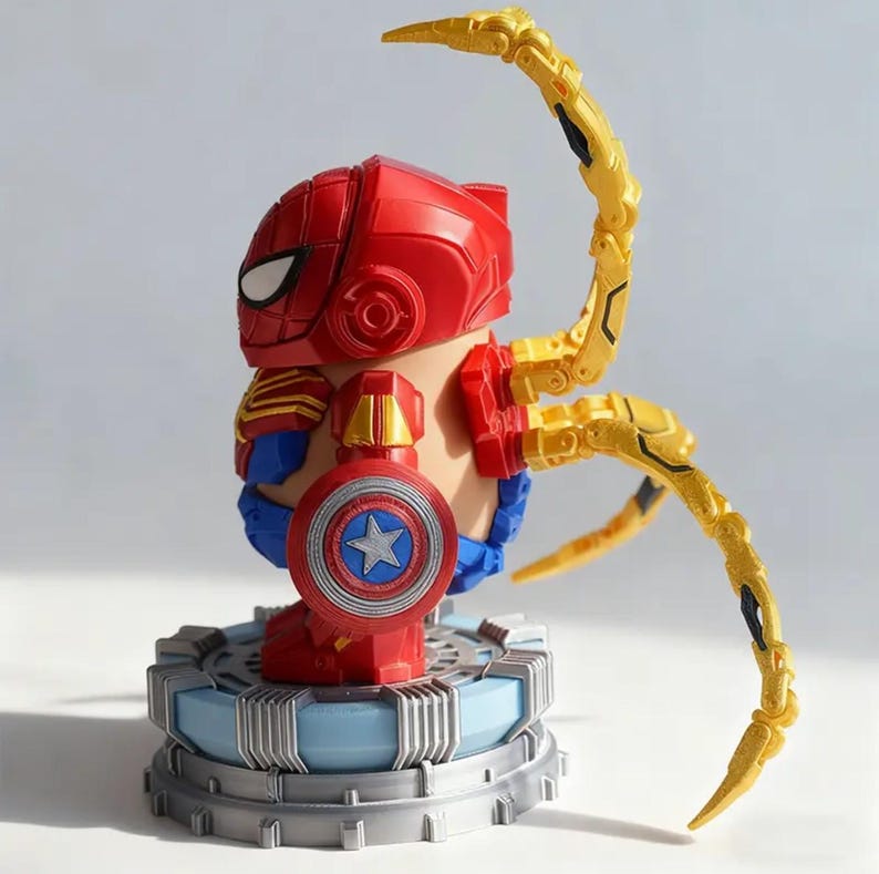 May include: A red and gold Spider-Man figure with a Captain America shield. The figure has articulated gold arms and is standing on a blue and gray platform. The figure's head is red with white eye details.