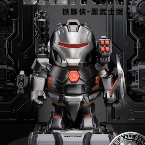 May include: A black and silver action figure of a character from the "Iron Pig" series, with the text "DALITUN" at the top. The figure has a red and silver helmet and is posed on a gray base. The figure has a gun on its left arm.