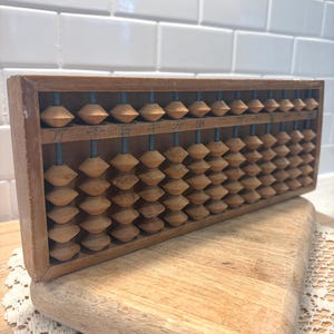 May include: A rustic wooden sign with the text "Welcome to our home" in a handwritten style. The sign features a distressed finish and a simple, inviting design, perfect for a front porch or entryway.