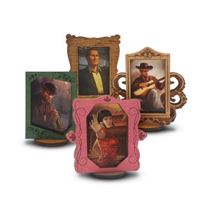 Puede incluir: Un conjunto de cuatro marcos de fotos de madera, cada uno con un diseño e imagen únicos. Los marcos son de varios colores, incluyendo marrón, verde y rosa. Las imágenes representan a un hombre, una mujer y dos músicos. Los marcos están sobre pequeños soportes de madera.