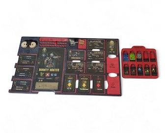May include: A black and red board game organizer with various compartments and card slots. The organizer features cards with illustrations and text, including "Bounty Hunter." A separate red tray holds additional game pieces.