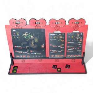 May include: A red wooden tabletop game organiser with four HP counters. The organiser holds three game cards and has a shelf for game pieces. The cards feature illustrations and text. The HP counters display numbers.