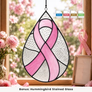 May include: A teardrop-shaped stained glass suncatcher featuring a pink awareness ribbon design. The piece is constructed with black metal cames and textured clear glass panels. It hangs from a black cord and includes digital file icons.