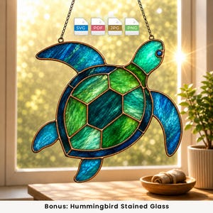 May include: A stained glass sea turtle suncatcher featuring vibrant green and blue textured glass panels held together by dark metal soldering. The piece includes a metal chain for hanging and digital file icons labelled SVG, PDF, JPG, and PNG.