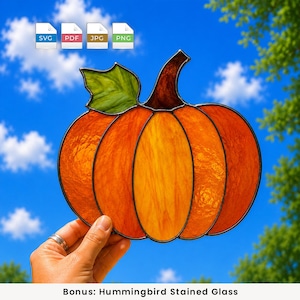 May include: A stained glass pumpkin suncatcher featuring vibrant orange glass segments with textured surfaces, a dark brown stem, and a single green leaf. The piece is outlined in black metal solder and includes digital file icons for SVG, PDF, JPG, and PNG.