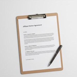 May include: A clipboard with a white document titled "Affiliate Partner Agreement" and a black pen. The document has several sections, including "Intellectual Property" and "Term and Termination."