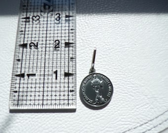 May include: A small, silver-colored pendant with a loop for a chain. The pendant is round, with an image of a saint and the words "ST. FRANCIS OF ASSISI PROTECT MY PET". The pendant is approximately 0.75 inches in diameter.