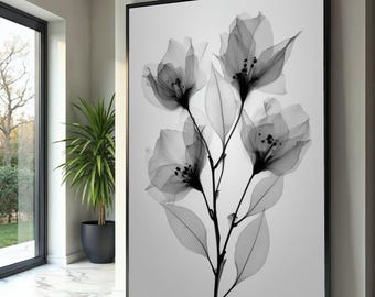 May include: Black and white floral art print. The artwork features a close-up of delicate flowers with translucent petals and leaves, set against a light background. The print is framed in a black border.