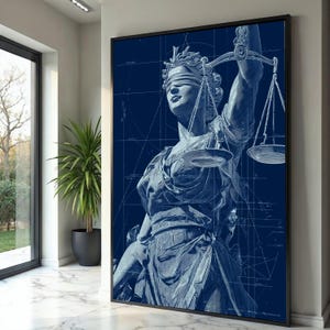May include: A framed wall art print featuring a dark blue monochromatic illustration of Lady Justice. The figure is blindfolded and holds a set of scales, set against a background of white technical blueprint lines and geometric drafting grids.