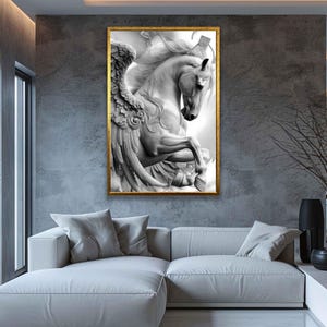 May include: A framed black and white artwork depicting a winged horse, possibly Pegasus, in a dynamic pose. The artwork is set against a neutral background, with a gold-colored frame. The image is a detailed sculpture, adding a touch of classical art to the room.