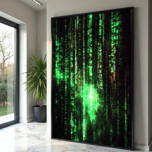 May include: Large framed artwork featuring a digital rain design in shades of green and black. The artwork has a black frame and is displayed in a modern interior setting with a large window and a potted plant.