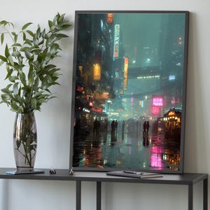 May include: A framed art print showing a neon-lit city at night. The image features a rainy street scene with bright pink, yellow, and teal lights reflecting on the wet ground. Silhouetted figures are walking along the street.