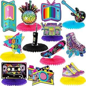 May include: A collection of colorful 80s and 90s themed party decorations. Includes a retro TV, boombox, roller skates, skateboard, cassette tape, camera, and a guitar. Each item is decorated with bright colors and geometric patterns.