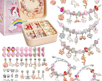 May include: A pink jewelry set for girls, featuring a variety of charms, beads, and bracelets. The set includes a jewelry box, a gift bag with a unicorn, and several bracelets with charms like unicorns, shells, and flowers.