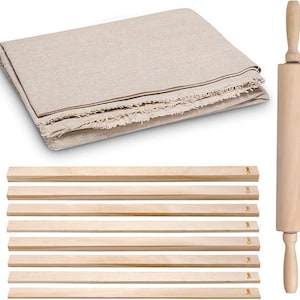 May include: A beige linen fabric, a wooden rolling pin, and several wooden strips are displayed. The rolling pin is made of light-colored wood. The wooden strips have measurements printed on them, ranging from 3mm to 12mm. The linen fabric is folded.