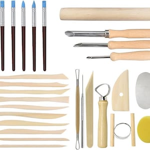 May include: A collection of pottery tools, including brushes with blue tips, wooden modeling tools, and metal sculpting tools. The set also includes a sponge and wire tools, ideal for various clay projects.