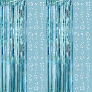 May include: Turquoise and blue metallic fringe curtains with strings of clear bubble-shaped ornaments. The background is a light blue. The vertical fringe creates a shimmering effect, suitable for party decorations or backdrops.