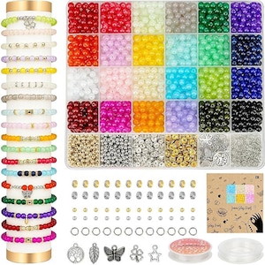 May include: A jewelry-making kit with a variety of colorful beads in a clear divided container. The kit includes bracelets, charms, clasps, and string. A stack of bracelets in various colors is displayed on the left.
