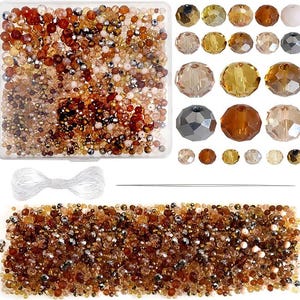 May include: A collection of assorted beads in shades of brown, gold, and clear, displayed in a clear plastic container and scattered. Includes a white string and a needle. Ideal for jewelry making and crafting projects.