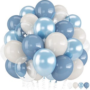 May include: A large cluster of round balloons in shades of dusty blue, light blue, and cream white. The balloons have a smooth, reflective surface with visible highlights. Several clear, transparent balloons are interspersed throughout the arrangement.