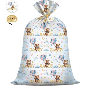 May include: A large, light blue gift bag featuring a repeating pattern of teddy bears with balloons, clouds, and crescent moons. The word "BABY" is printed in gold. A matching tag and rope are included.