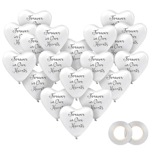 May include: A collection of white heart-shaped balloons with the phrase "Forever in Our Hearts" printed in black. Two rolls of clear double-sided tape are visible at the bottom. The balloons are arranged in a heart shape.