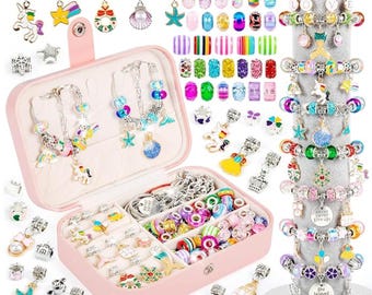 May include: A pink jewelry box filled with colorful beads, charms, and bracelets. The charms include stars, unicorns, and seashells. Several bracelets are displayed on a gray stand. Necklaces with various pendants are also visible.