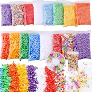 May include: A collection of colorful craft supplies, including bags of foam beads in various colors like purple, red, and green. Also shown are a container of nail art decorations and a bag of confetti.