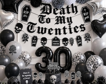 May include: A black and white themed 30th birthday party setup. Decorations include balloons, a banner that reads "Death To My Twenties", and a cake with a skull design. Other decorations include skulls, roses, and the text "Cheers to the beginning of forever".