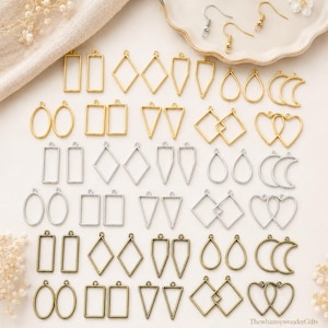 May include: A collection of gold, silver, and bronze-toned earring blanks in various geometric shapes, including rectangles, diamonds, triangles, teardrops, and hearts. Some blanks have matching earring hooks.