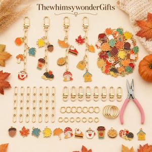 May include: A DIY jewelry making kit featuring gold-tone metal chains, lobster clasps, jump rings, and various autumn-themed enamel charms including pumpkins, leaves, mushrooms, and hedgehogs. Includes pink-handled pliers for assembly.