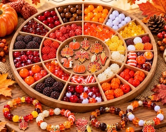 May include: A circular wooden organizer tray filled with assorted autumn-themed beads in shades of red, orange, yellow, and white, alongside metal charms shaped like pumpkins, leaves, squirrels, and turkeys, with four beaded bracelets below.