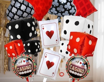 May include: Casino-themed party balloons in various shapes, including dice, playing cards, and suit symbols. The balloons are red, black, white, and silver. Some balloons have the word "CASINO" on them.