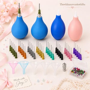 May include: A set of four squeeze bulbs with metal tips, multiple sets of colored needle tips, five clear plastic funnels, a metal adapter, and a small clear box filled with multicolored sewing pins. The text "Made with Joy" is visible.