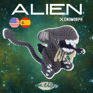 May include: A crocheted Xenomorph alien figure in shades of gray, black, and white. The figure has a long tail, a detailed head, and sharp teeth. The word "ALIEN" is at the top, with "Xenomorph" below it. The background is a space scene.