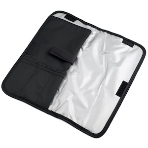 May include: A black rectangular folding organiser with a silver-coloured insulated interior lining. The organiser features a black fabric flap with three vertical storage slots and a hook-and-loop fastener strap to secure the item when folded closed.